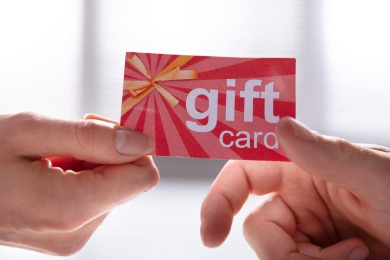 Female Hand Giving Gift Card To Her Partner
