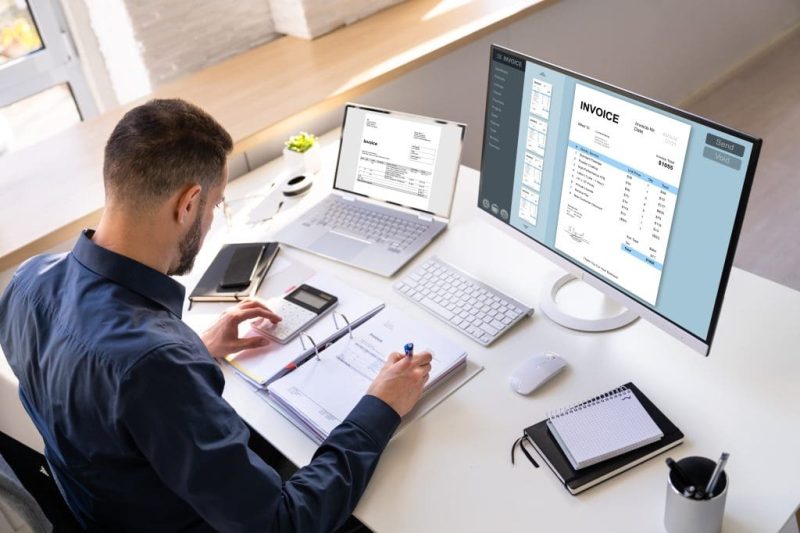 Accountant Using E Invoice Software At Computer